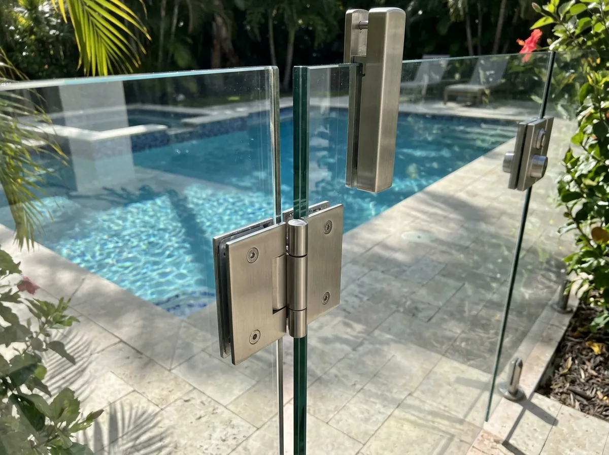 Self-closing frameless glass pool gate with stainless hinges and a tall latch